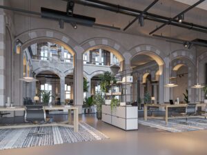 Modern kantoorinterieur met hoge plafonds, bogen en eigentijdse werkplekken aan de Nieuwezijds Voorburgwal.